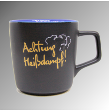 schwarze Keramiktasse SDG, Außendruck "Achtung Heißdampf", innenseite blau glänzend, Bodendruck "Füllstand kritisch!"